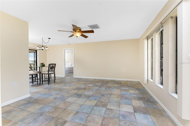39 Bunker Pl, Rotonda West, FL 33947 - unfurnished room with stone finish flooring, baseboards, visible vents, and ceiling fan with notable chandelier