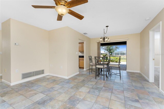 39 Bunker Pl, Rotonda West, FL 33947 - dining area with stone tile floors, baseboards, visible vents, and ceiling fan with notable chandelier
