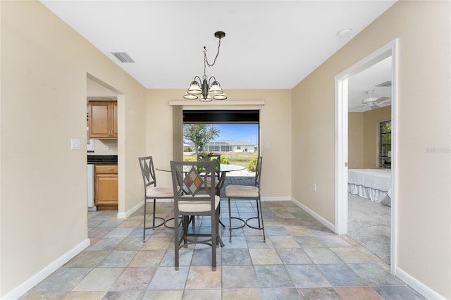 39 Bunker Pl, Rotonda West, FL 33947 - dining area featuring stone finish flooring, baseboards, a notable chandelier, and visible vents