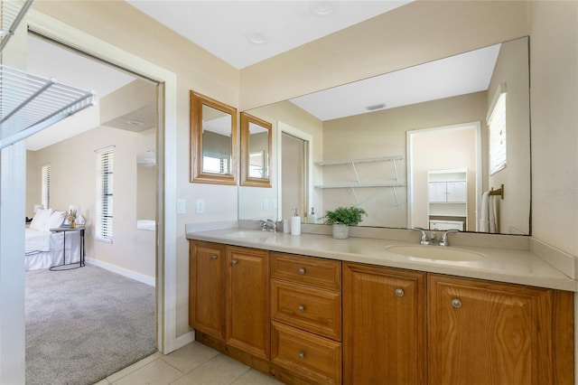 39 Bunker Pl, Rotonda West, FL 33947 - bathroom featuring visible vents, a sink, double vanity, and a healthy amount of sunlight
