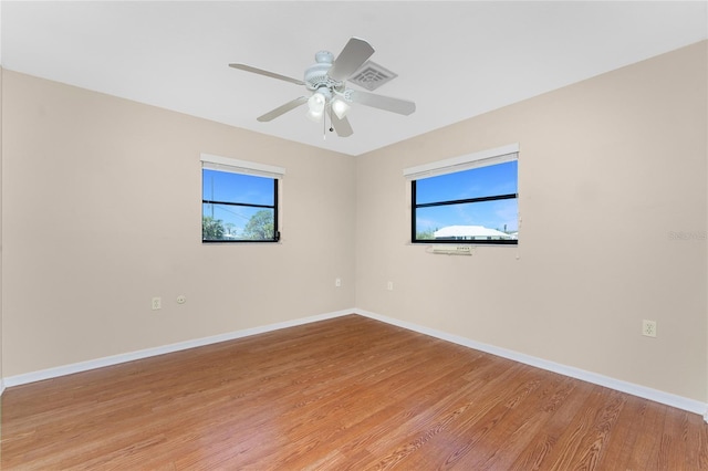 39 Bunker Pl, Rotonda West, FL 33947 - spare room featuring plenty of natural light, light wood finished floors, and baseboards