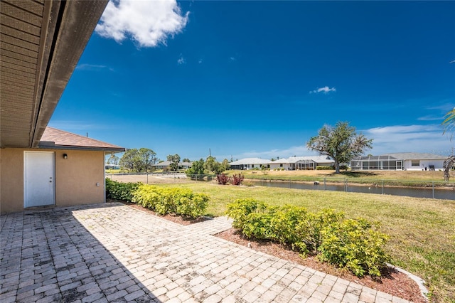 39 Bunker Pl, Rotonda West, FL 33947 - view of patio / terrace with fence, a water view, and a residential view