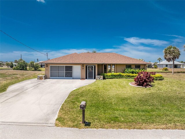 39 Bunker Pl, Rotonda West, FL 33947 - ranch-style house with an attached garage, driveway, a front lawn, and stucco siding