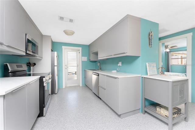 1245 Gulf Blvd, Englewood, FL 34223 - kitchen featuring visible vents, a sink, gray cabinets, and stainless steel appliances