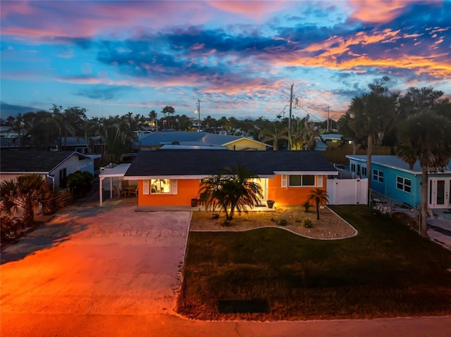 1245 Gulf Blvd, Englewood, FL 34223 - single story home with fence, a gate, a lawn, driveway, and a carport