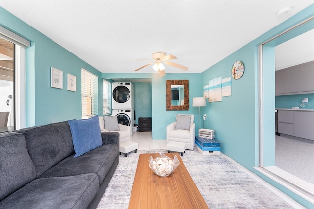 1245 Gulf Blvd, Englewood, FL 34223 - living area featuring stacked washer and dryer, a ceiling fan, and baseboards