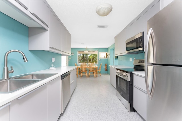 1245 Gulf Blvd, Englewood, FL 34223 - kitchen featuring visible vents, light speckled floor, light countertops, a sink, and appliances with stainless steel finishes