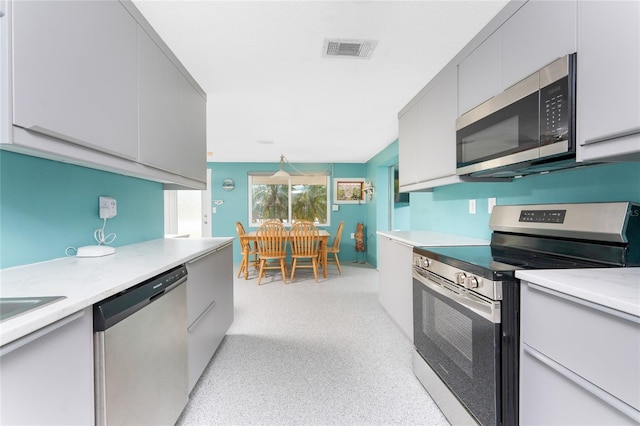 1245 Gulf Blvd, Englewood, FL 34223 - kitchen featuring visible vents, appliances with stainless steel finishes, and gray cabinetry