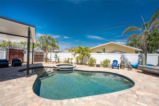 1245 Gulf Blvd, Englewood, FL 34223 - view of pool featuring a storage shed, a pool with connected hot tub, an outbuilding, a patio area, and a fenced backyard