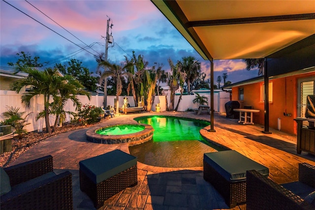1245 Gulf Blvd, Englewood, FL 34223 - pool at dusk featuring a patio, a fenced backyard, and a pool with connected hot tub