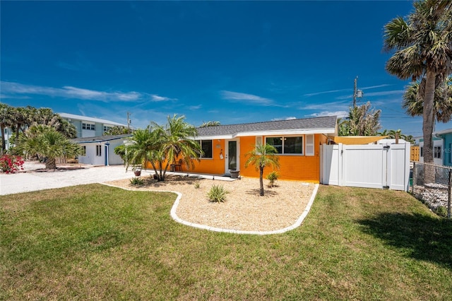 1245 Gulf Blvd, Englewood, FL 34223 - ranch-style house featuring fence, a gate, driveway, and a front yard