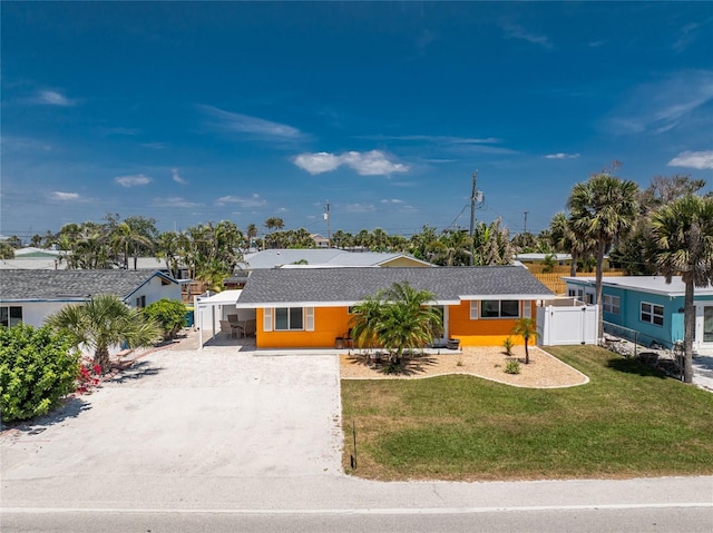 1245 Gulf Blvd, Englewood, FL 34223 - ranch-style home with a front lawn, fence, and driveway