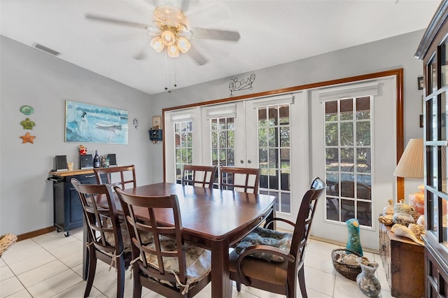 dining area with a ceiling fan, light tile patterned floors, french doors, baseboards, and visible vents