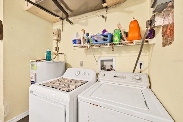 washroom with separate washer and dryer, water heater, and laundry area