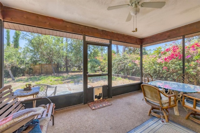 sunroom with ceiling fan, outdoor dining area, and plenty of natural light