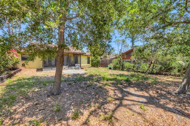 view of yard with a patio and fence
