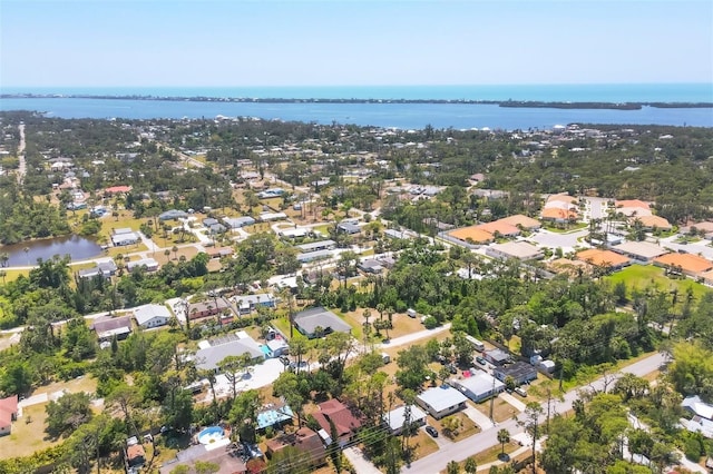 drone / aerial view with a residential view and a water view