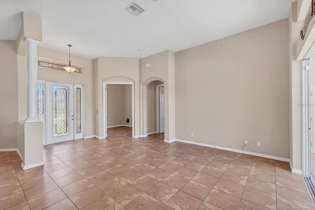 entryway with visible vents, baseboards, and arched walkways