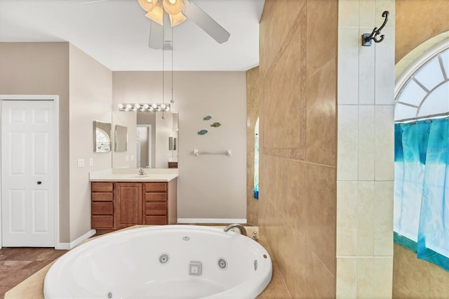 bathroom with a tub with jets, a ceiling fan, tiled shower, and vanity