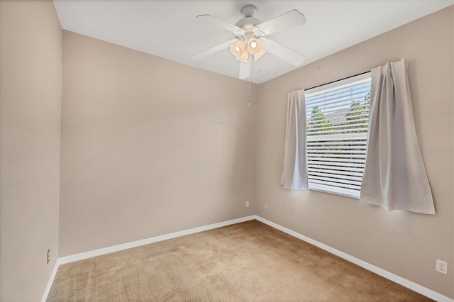unfurnished room featuring carpet, ceiling fan, and baseboards