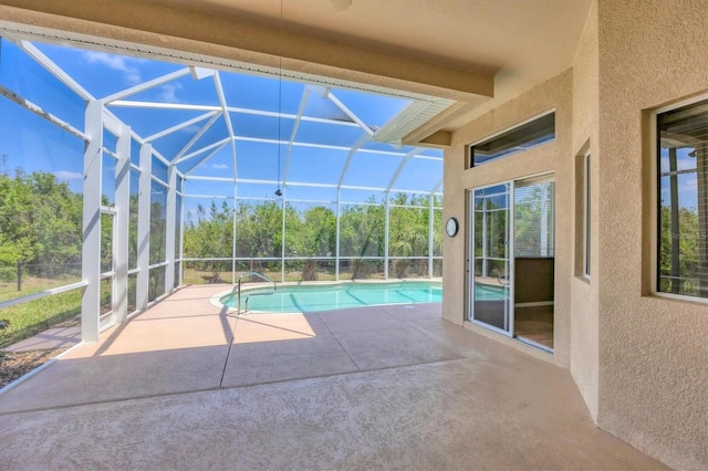 outdoor pool with a lanai and a patio area
