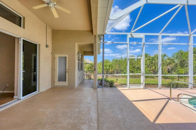 view of patio featuring a ceiling fan and a lanai