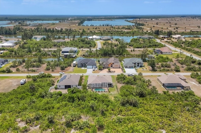 drone / aerial view featuring a residential view and a water view