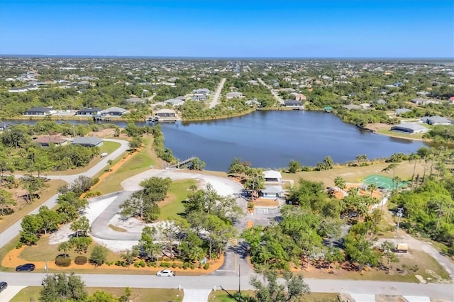 drone / aerial view featuring a water view and a residential view