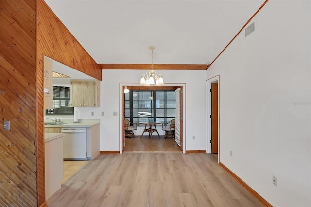 interior space featuring a notable chandelier, dishwasher, a wealth of natural light, and light wood-style floors