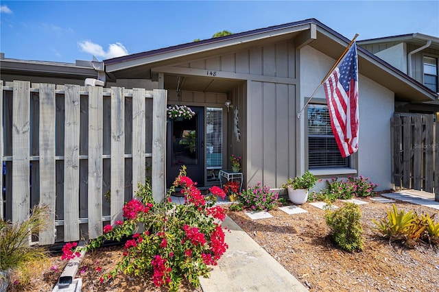 view of exterior entry featuring fence