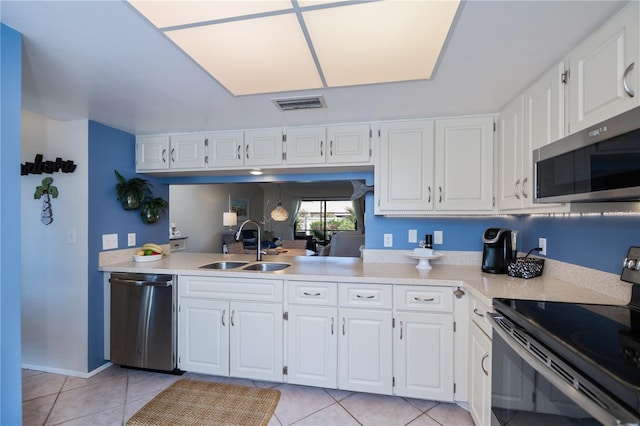 kitchen featuring light countertops, visible vents, stainless steel appliances, and a sink
