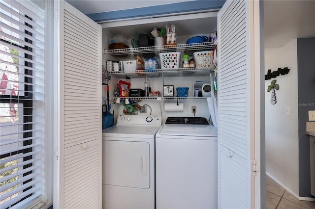 laundry room featuring baseboards, independent washer and dryer, laundry area, and light tile patterned flooring