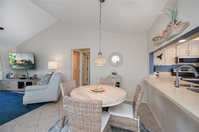dining room with lofted ceiling and light tile patterned floors