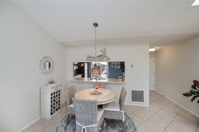 dining space featuring an inviting chandelier, visible vents, baseboards, and light tile patterned floors