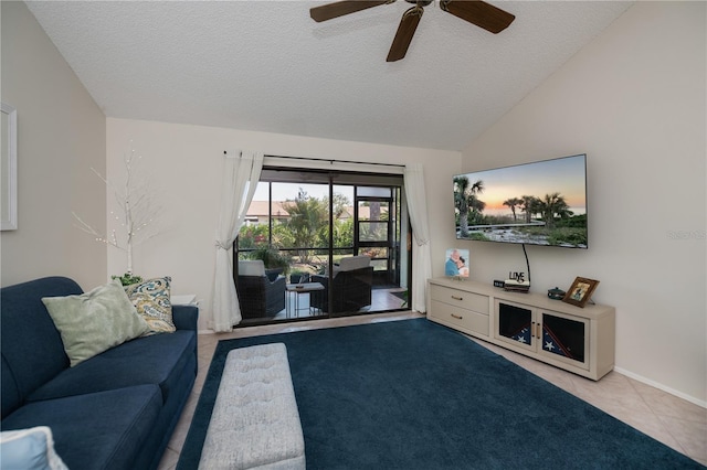living room with lofted ceiling, a ceiling fan, baseboards, and a textured ceiling