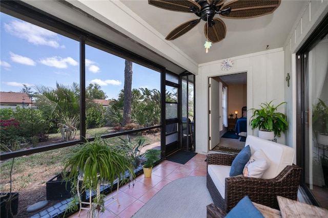 sunroom with tile patterned floors and ceiling fan