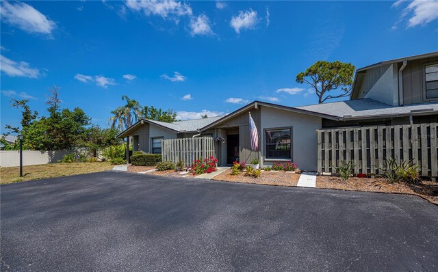 view of front of property with fence and stucco siding