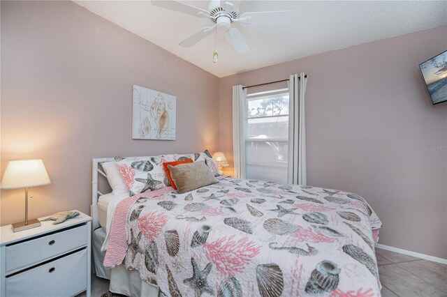 bedroom with tile patterned flooring, baseboards, and ceiling fan