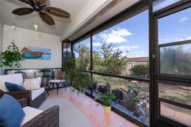 sunroom / solarium with a ceiling fan
