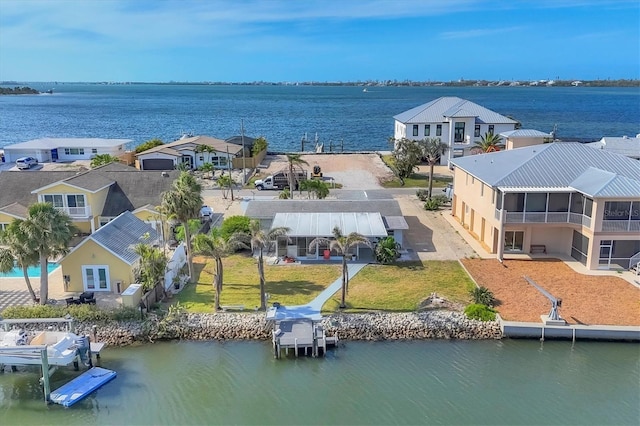 drone / aerial view featuring a water view and a residential view