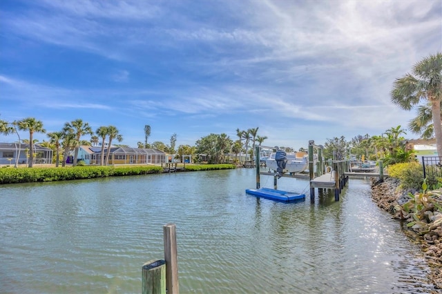 dock area with boat lift and a water view