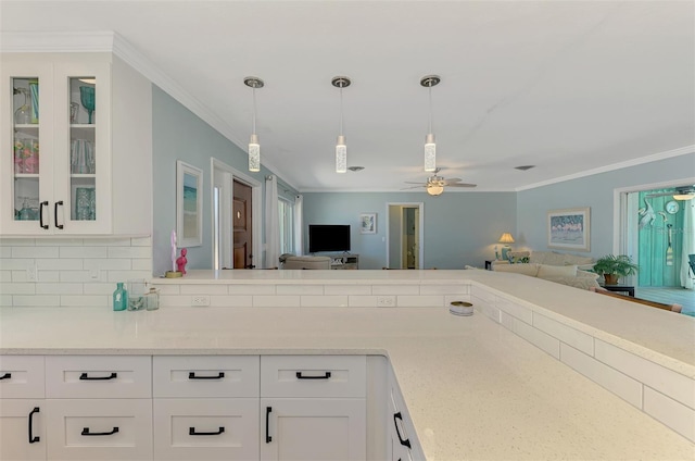 1915 Illinois Ave, Englewood, FL 34224 - kitchen with crown molding, a ceiling fan, open floor plan, and white cabinets