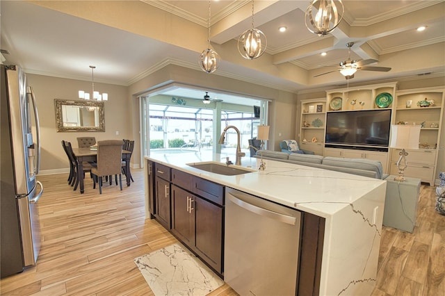 35 Medalist Rd, Rotonda West, FL 33947 - kitchen with stainless steel appliances, ceiling fan, dark brown cabinets, light wood-style floors, and ornamental molding