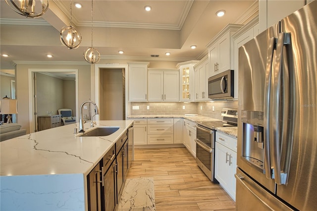 35 Medalist Rd, Rotonda West, FL 33947 - kitchen featuring stainless steel appliances, light wood-style flooring, crown molding, glass insert cabinets, and decorative backsplash