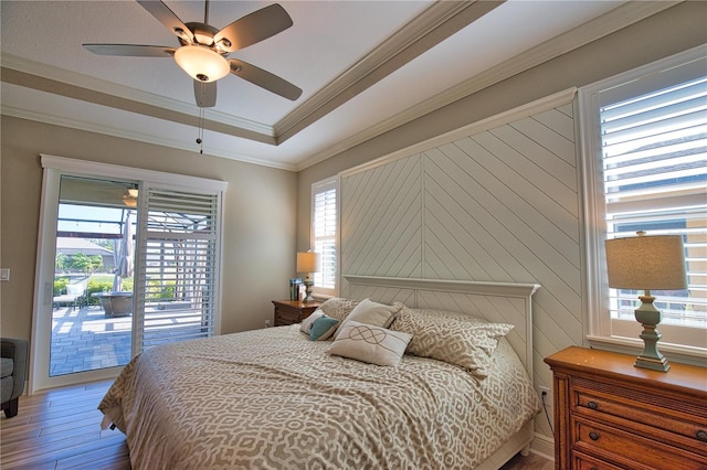 35 Medalist Rd, Rotonda West, FL 33947 - bedroom featuring access to outside, wood finished floors, multiple windows, ornamental molding, and a ceiling fan