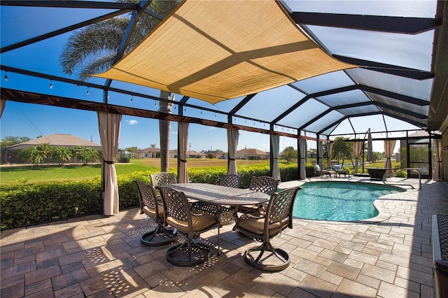 35 Medalist Rd, Rotonda West, FL 33947 - swimming pool featuring a patio, glass enclosure, and outdoor dining space