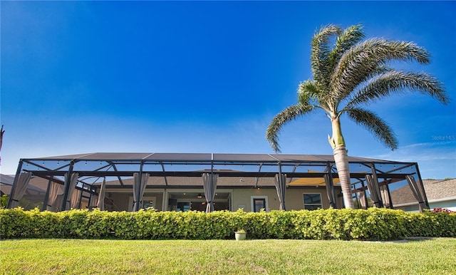 35 Medalist Rd, Rotonda West, FL 33947 - back of house featuring a lawn and a lanai