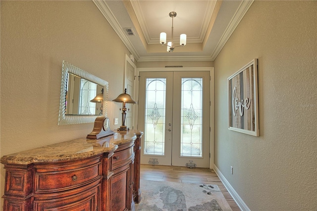 35 Medalist Rd, Rotonda West, FL 33947 - entryway featuring french doors, healthy amount of natural light, light wood-style floors, a textured wall, and a tray ceiling