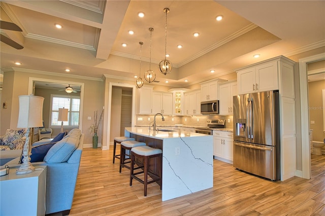 35 Medalist Rd, Rotonda West, FL 33947 - kitchen featuring stainless steel appliances, a ceiling fan, light wood finished floors, a kitchen breakfast bar, and recessed lighting