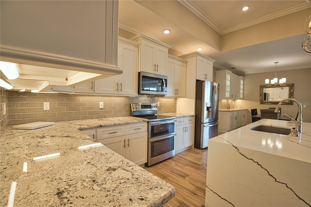 35 Medalist Rd, Rotonda West, FL 33947 - kitchen featuring stainless steel appliances, crown molding, tasteful backsplash, white cabinets, and recessed lighting